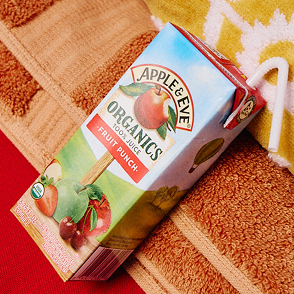Organic Apple Juice Box on a red towel. 